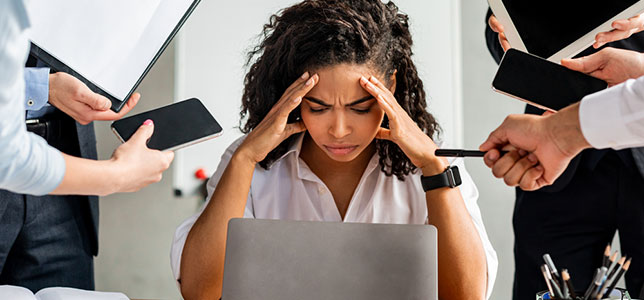 stressed woman sitting at laptop
